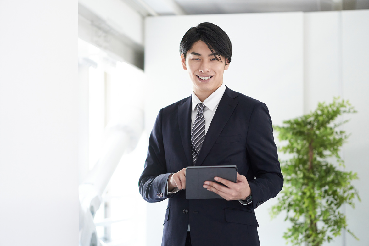 Smiling Businessman Using a Tablet